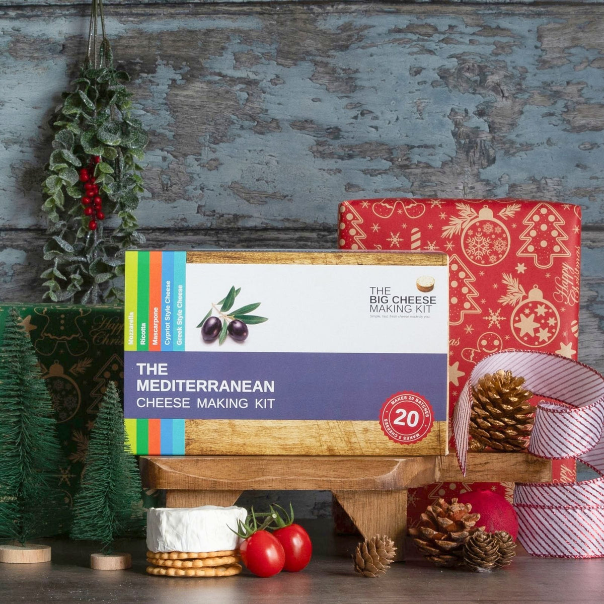 The Mediterranean Cheese Making Kit in front of a wrapped Christmas present
