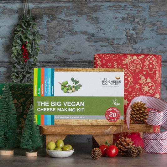 The Big Vegan Cheese Making Kit in front of a wrapped Christmas present