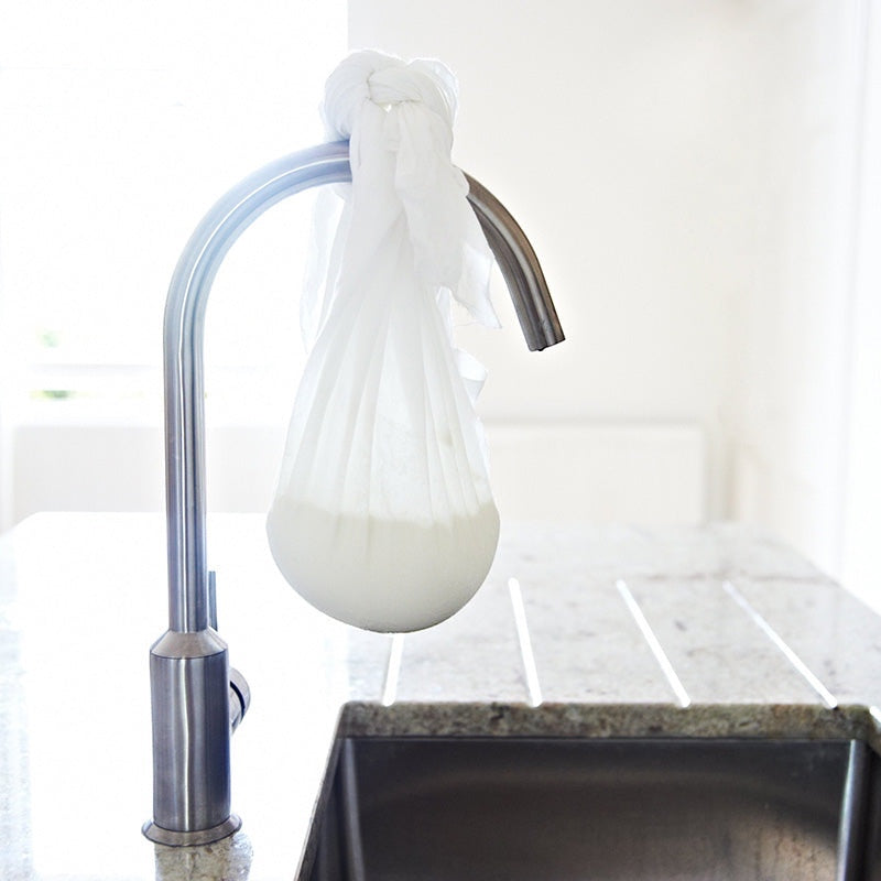 Big Cheese Making Kit Scottish Crowdie cheese making process, cheese draining in cloth bag hanging from faucet.