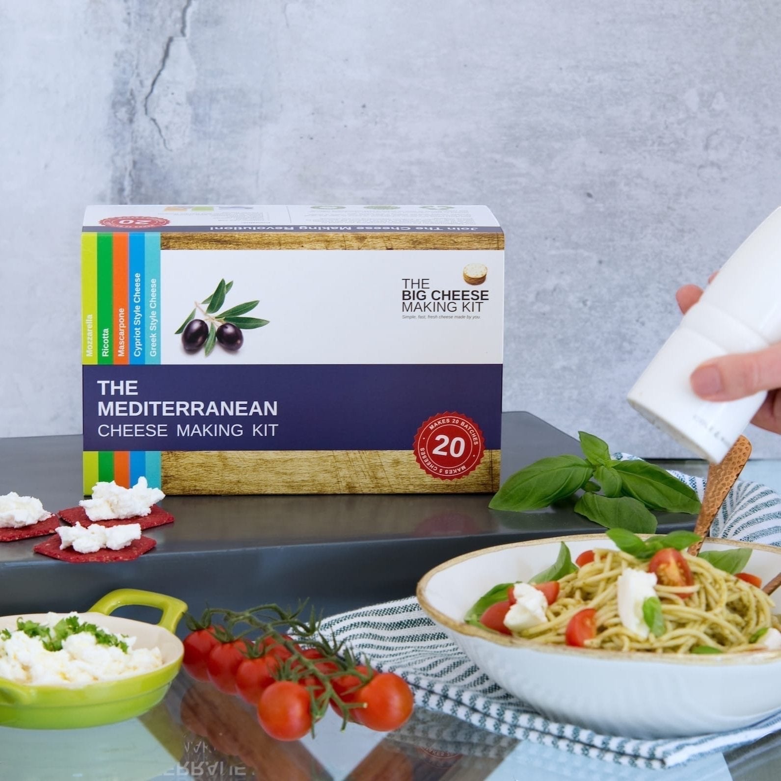 The Big Cheese Making Kit Mediterranean Cheese Making Kit box with ingredients and finished cheese dishes.