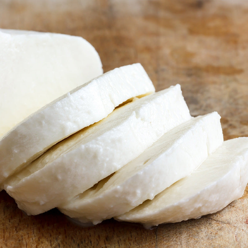 sliced mozarella made by the home made big cheese making kit on a wooden chopping board