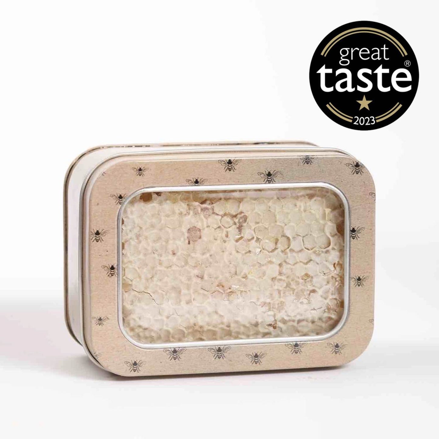 A rectangular tin containing raw Scottish heather honeycomb, with a clear window displaying the honey inside.