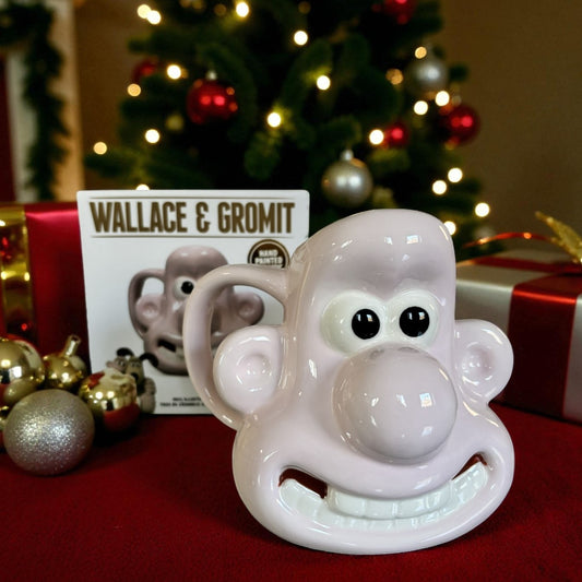 Wallace & Gromit-themed face mug with Christmas tree and decorations in the background